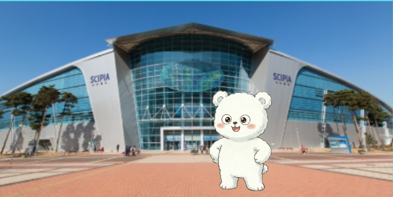 Popgom the bear character standing in front of the Gwacheon National Science Museum main building